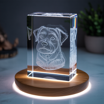 glowing crystal memorial block on wooden table with soft candlelight in background